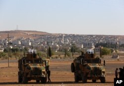 FILE - Turkish soldiers take up position a few hundreds meters from the border with Syria as fighting intensified with Islamic State militants.