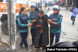 Police in Dhaka arrest a female BNP activist. After the election schedule was announced in November, about 12,300 opposition party leaders and workers reportedly were arrested. (VOA/Babul Talukder).