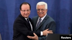 Presiden Perancis Francois Hollande (kiri) memeluk Presiden Palestina Mahmoud Abbas seusai konferensi pers bersama di Ramallah, Tepi Barat (18/11). 