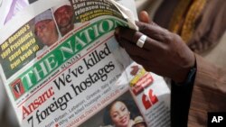 A man reads a local newspapers with the headline 'We've killed 7 foreign hostages' on a street in Kano, Nigeria, Sunday, Mar. 10, 2013. 