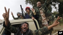 Anti-Gadhafi fighters celebrate in Libyan city of Benghazi, Feb. 27, 2011.