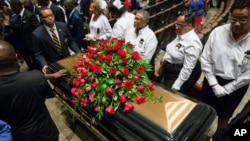 A casket containing the body of Michael Brown is wheeled out at Friendly Temple Missionary Baptist Church in St. Louis, Missouri, Aug. 25, 2014. 