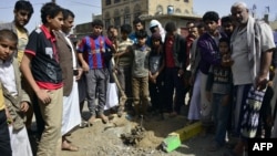 Yemenis gather at the site of a bomb explosion that targeted an army troop vehicle on its way to man a checkpoint in Sana'a. (FILE)