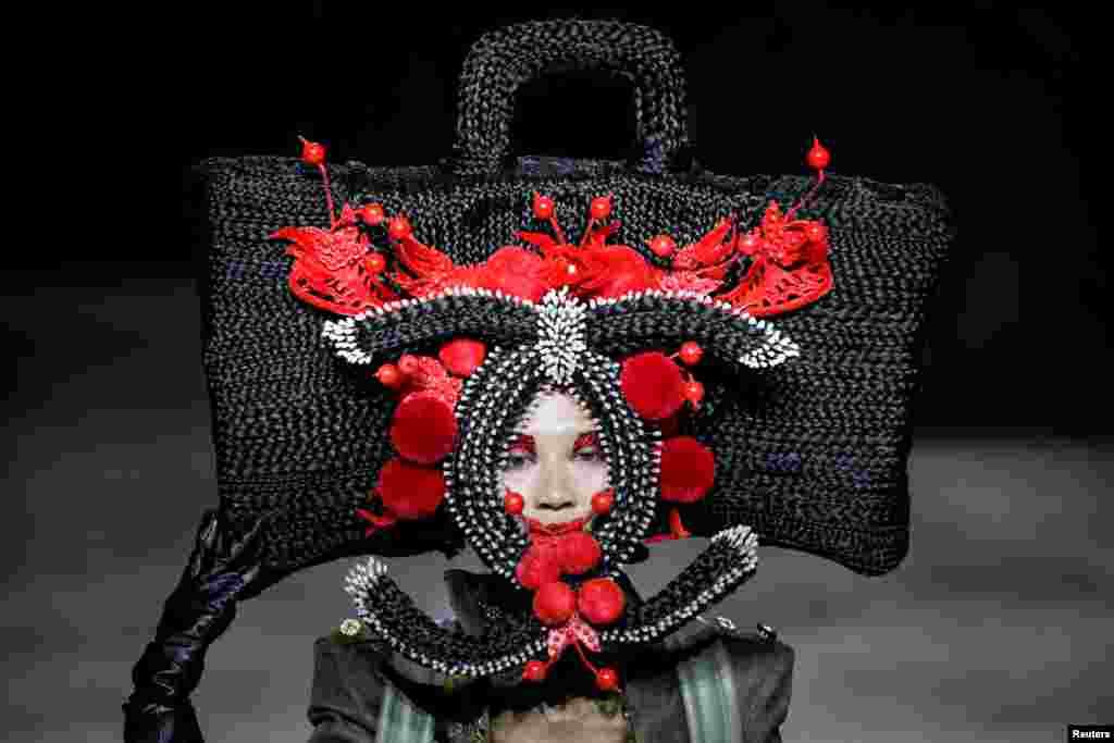 A model presents a creation by designer Hu Sheguang at China Fashion Week in Beijing, China.