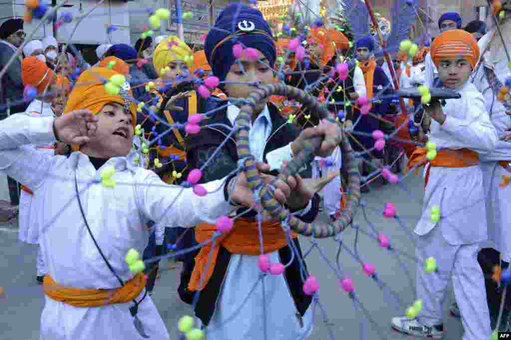 Sikh youth perform &quot;Gatka,&quot; an ancient form of Sikh martial arts, during a religious procession on the eve of martyrdom day of the ninth Sikh Guru Tegh Bahadur in Amritsar, India.