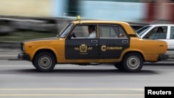 A man drives his Soviet-era Russian Lada taxi in Havana, Jan. 8, 2014.