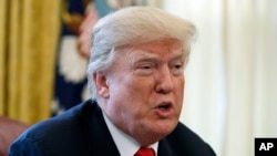 FILE - President Donald Trump speaks with reporters in the Oval Office of the White House in Washington, Dec. 22, 2017.