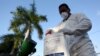 FILE - A health worker prepares insecticide before fumigating a neighborhood in San Juan, Puerto Rico, Jan. 27, 2016.