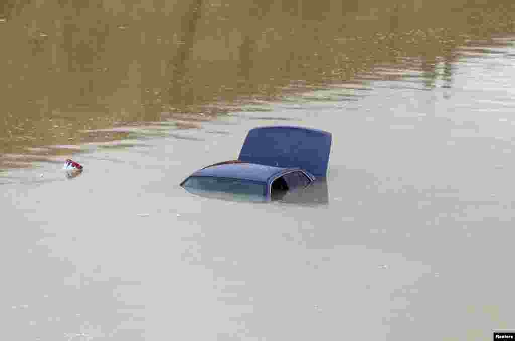 A car is submerged in flood waters following heavy rain, in Riyadh, Saudi Arabia.