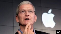 FILE - Apple CEO Tim Cook responds to a question during a news conference at IBM Watson headquarters, in New York. 