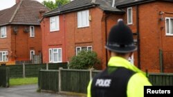 A policeman stands outside a residential property in south Manchester, Britain, May 24, 2017. 