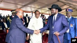 President Omar al-Bashir of Sudan, left, and President Salva Kiir of South Sudan shake hands during the inauguration ceremony of Uganda's long-time president Yoweri Museveni in the capital Kampala, May 12, 2016.