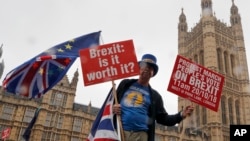 A demonstrator protests in front of parliament in London, Oct. 17, 2018. 
