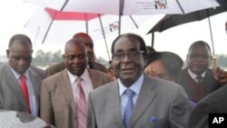 Zimbabwean President Robert Mugabe, arriving back in Harare from Singapore Thursday, April 12, 2012 as his party denied reports he had suffered a health emergency. (AP Photo)