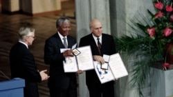 FILE - In this photo taken on Dec. 09, 1993, Nelson Mandela, President of South African African National Congress (C) and South African President Frederik de Klerk (R) display in Oslo their Nobel Prizes after being awarded jointly for their work to end ap