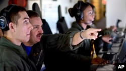 This photo provided by the Argentine Navy shows U.S. Navy members searching for Argentina's missing ARA San Juan submarine as they fly over the Southern Atlantic, after leaving a base in Bahia Blanca, Argentina, Nov. 27, 2017.