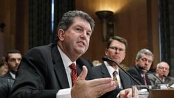 Postmaster General Patrick Donahoe, left, speaks to the Senate Homeland Security and Governmental Affairs Committee in Washington, Tuesday. Next to him is John Berry, director of the Office of Personnel Management.