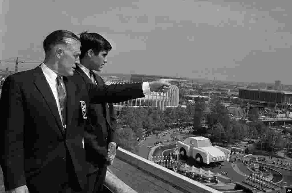 Gov. George Romney and his son, Mitt, look out over the New York World's Fair grounds from the heliport after attending a Michigan breakfast at the Top of the Fair Restaurant, May 18, 1964.