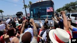 Demonstrators block a bus with immigrant children aboard during a protest outside the U.S. Border Patrol Central Processing Center, June 23, 2018, in McAllen, Texas. Extra law enforcement officials were called in to help control the scene and allow the bus to move.