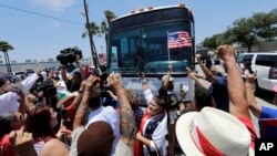 FILE - Demonstrators block a bus with immigrant children aboard during a protest outside the U.S. Border Patrol Central Processing Center, June 23, 2018, in McAllen, Texas. 