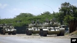 African Union tanks are seen guarding in front of their base in the Somali capital of Mogadishu, October 29, 2011.