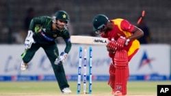 FILE: Pakistan's Mohammad Rizwan unsuccessfully tries to remove stumps of Zimbabwe's Vusimuzi Sibanda during a match at the Gaddafi Stadium in Lahore, Pakistan, Sunday, May 24, 2015. (AP Photo/B.K. Bangash)