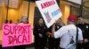 FILE - A supporter of President Donald Trump challenges police officers and a Deferred Action for Childhood Arrivals (DACA) program advocate during a rally in Los Angeles, California, Jan. 3, 2018. 