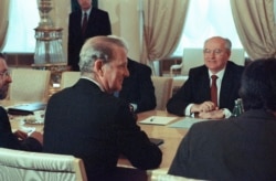 FILE - Soviet President Mikhail Gorbachev and U.S. Secretary of State James Baker face each other at the Kremlin in Moscow, May 18, 1990, before the start of talks on arms control issues in preparation for an upcoming U.S.-Soviet summit in Washington.