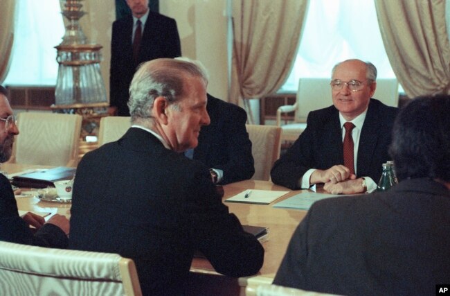 FILE - Soviet President Mikhail Gorbachev and U.S. Secretary of State James Baker face each other at the Kremlin in Moscow, May 18, 1990, before the start of talks on arms control issues in preparation for an upcoming U.S.-Soviet summit in Washington.