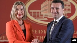 European Union High Representative for Foreign Affairs and Security Policy Federica Mogherini, left, and Macedonian Prime Minister Zoran Zaev pose for a photo, following their meeting at the government building in Skopje, Macedonia, April 18, 2018. 