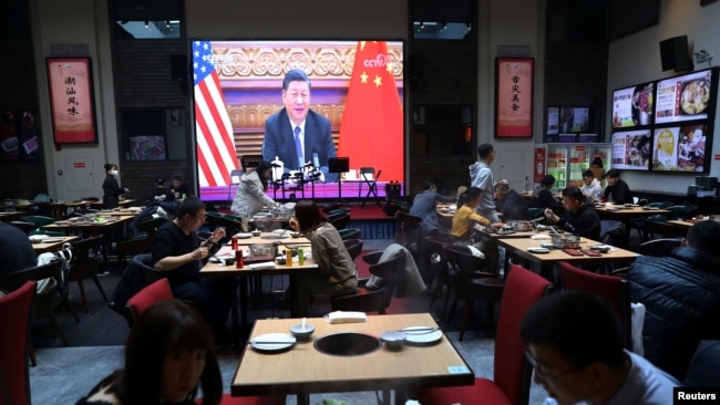A screen shows Chinese President Xi Jinping attending a virtual meeting with U.S. President Joe Biden via video link, at a restaurant in Beijing, China November 16, 2021