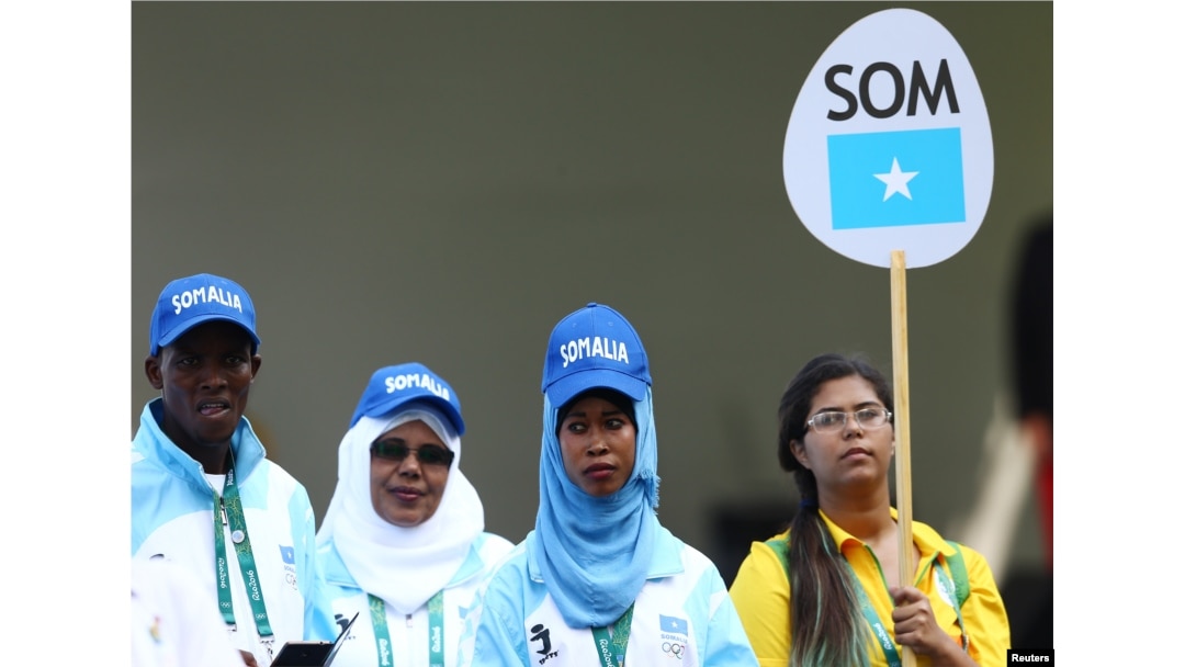 Mohamed Daud Mohamed, left, and Maryam Nuh Muse, second from right, are pictured with another member of their contingent during team-welcoming ceremonies for the 2016 Rio Olympics in Rio de Janeiro, Brazil, Aug. 4, 2016.
