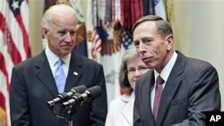 Director of the CIA, David Petraeus (R), speaks following his swearing-in ceremony with his wife Holly Knowlton Petraeus (C), and Vice President Joe Biden (L), in the Roosevelt Room of the White House in Washington, DC, September 6, 2011.