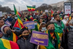 FILE - People from Ethiopian and Eritrea, supporters of Ethiopian Prime Minister Abiy Ahmed, participate in a protest in Washington, Dec. 10, 2021, against the U.S. and other western countries' intervention in their country and calling for the immediate e