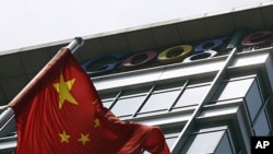 A Chinese national flag waves in front of the former headquarters of Google China in Beijing, June 2, 2011.