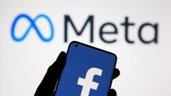 A smartphone with Facebook's logo is seen in front of displayed Facebook's new rebrand logo Meta in this illustration taken Oct. 28, 2021.