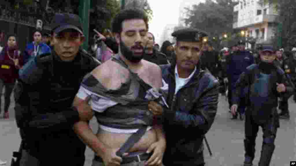 Egyptian police arrest a protester in Cairo, November 26, 2013.