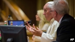 Pope Francis speaks in the Synod Hall at the Vatican during a conference on climate change and human trafficking, July 21, 2015.