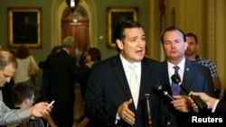 U.S. Senator Ted Cruz (C) and Senator Mike Lee (2nd R) speak to reporters about their opposition after the Senate passed a spending bill to avoid a government shutdown, at the U.S. Capitol in Washington, D.C., Sept. 27, 2013.