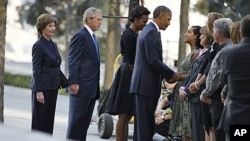 US President Barack Obama speaks with victims' relatives as he visits the north pool of the World Trade Center site with first lady Michelle Obama, former President George W. Bush and former first lady Laura Bush (L) during ceremonies marking the 10th ann