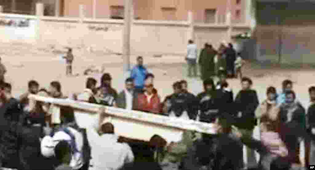 This image made from amateur video and released by Shaam News Network purports to Syrians carrying the coffin of a man killed by Syrian government forces during his funeral in Homs, Syria, March 13, 2012. (AP/Shaam)