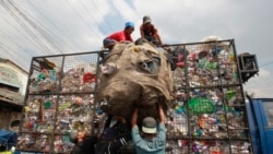 Workers load collected plastic bottles on to a truck at a junk shop in Manila, March 10, 2015. (REUTERS/Romeo Ranoco)