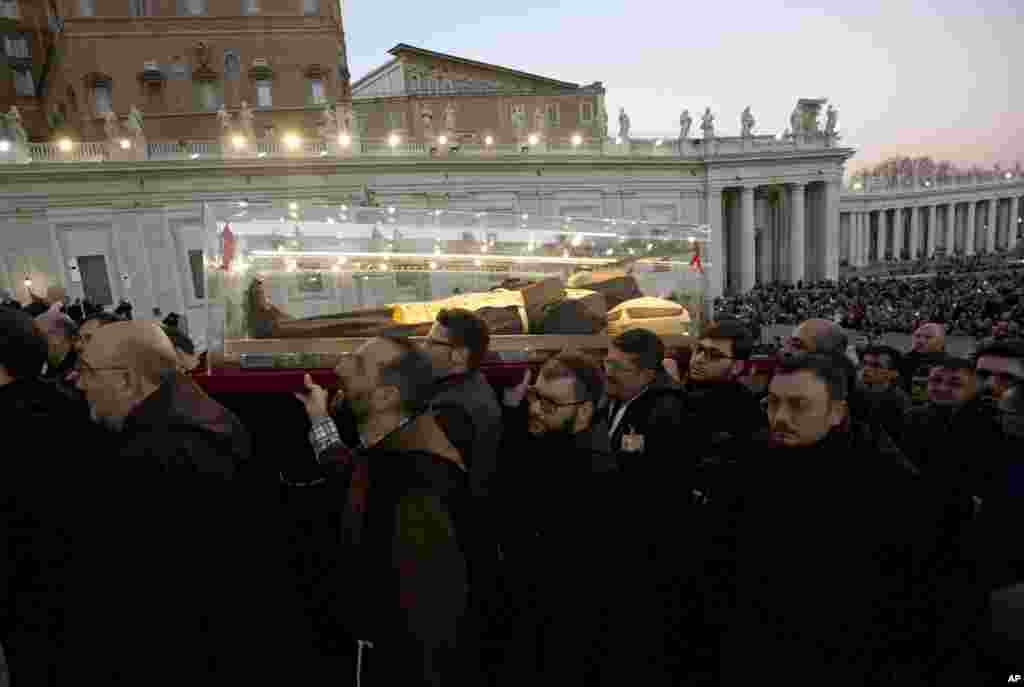 A box containing the corpse of Saint Pio da Pietralcina, who died in 1968, is carried in St. Peter&#39;s Square at the Vatican. Saint Pio, widely venerated in Italy and abroad, is famous for bearing the stigmata, which are the marks of Christ, and was canonized by Pope John Paul II in 2002.