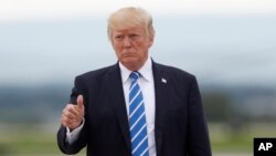 FILE - President Donald Trump gives a thumbs-up as walks to board on Air Force One at Hagerstown Regional Airport in Hagerstown, Md., Aug. 18, 2017.