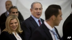 FILE - Israeli Prime Minister Benjamin Netanyahu and his wife Sara are seen arriving for the Likud party primary elections in Jerusalem in a Dec. 31, 2014, photo. 