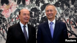 U.S. Commerce Secretary Wilbur Ross, left, chats with Chinese Vice Premier Liu He during a photograph session after their meeting at the Diaoyutai State Guesthouse in Beijing, China, June 3, 2018.