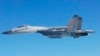 FILE - A Chinese SU-27 fighter flies over the East China Sea, in this handout photo taken May 24, 2014 and released by the Defense Ministry of Japan, May 25, 2014. 