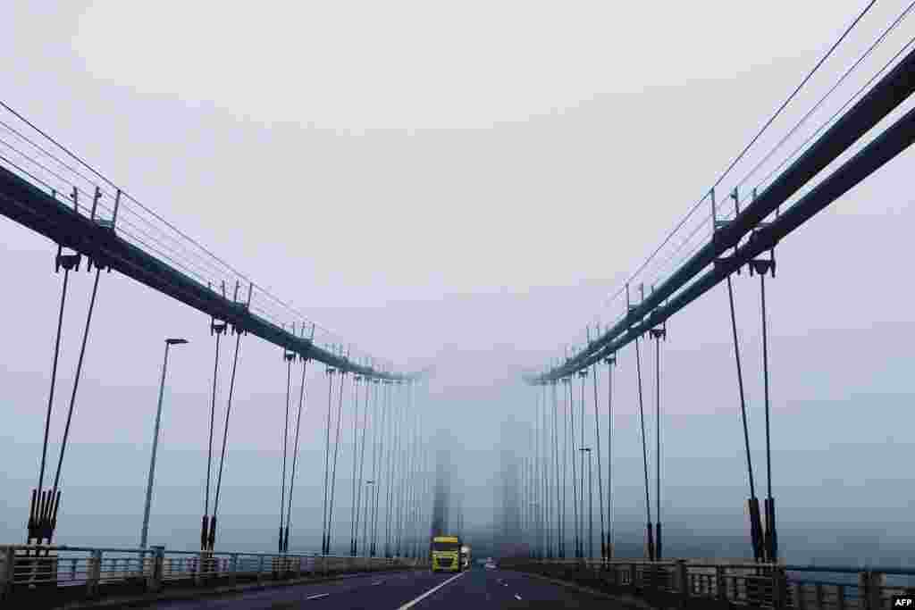 The Tancarville suspension bridge is seen in heavy for in northwestern France.