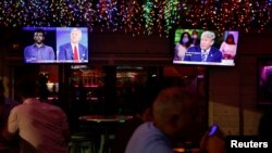 The dual town halls of U.S. Democratic presidential candidate Joe Biden and U.S. President Donald Trump, who are both running in the 2020 U.S. presidential election, are seen on television monitors at Luv Child restaurant ahead of the election in Tampa, Florida.