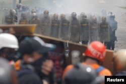 Venezuelan National Guard members take position while clashing with demonstrators rallying against Venezuela's President Nicolas Maduro in Caracas, Venezuela, June 6, 2017.